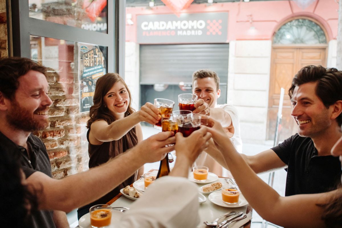 a group doing a cheers at lunch in Madrid.